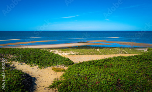 Seascape with deep blue ocean and scattered sandbars at low tide in Great Island in Wellfleet on Cape Cod