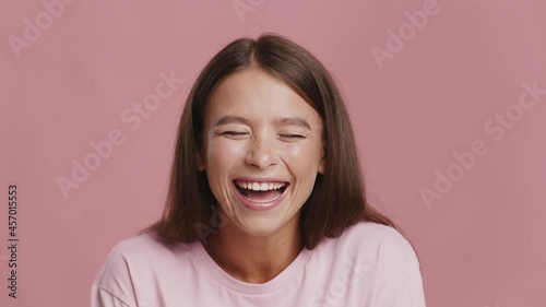 Young Lady Laughing Out Loud Looking At Camera, Pink Background