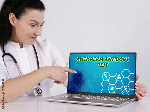  ANTISPERM ANTIBODY TEST phrase on the screen. Nurse use internet technologies at office. photo