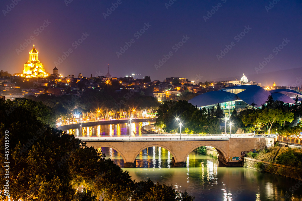 Scenic view of Mtkvari river and Holy Trinity Cathedral at night