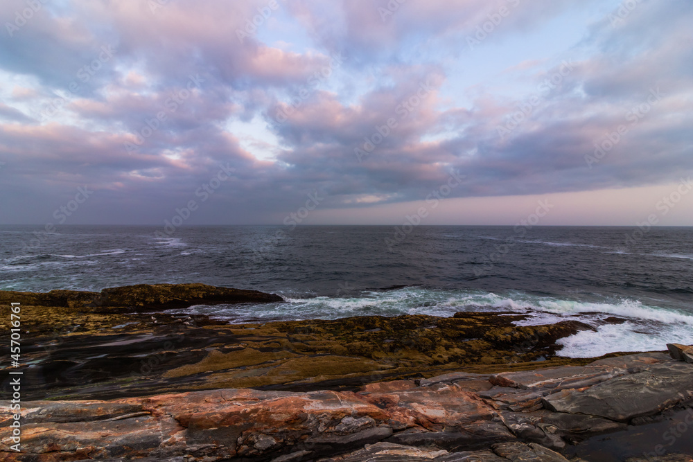 Coastal Maine rocky coast view from Pemaquid Point Lighthouse in Bristol, Maine, at sunset on a summer evening
