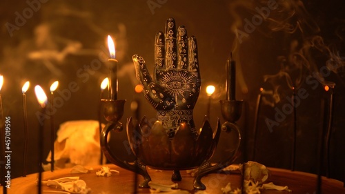 Картината върху платно Palmistry and table statue of the black hand at fortune teller table