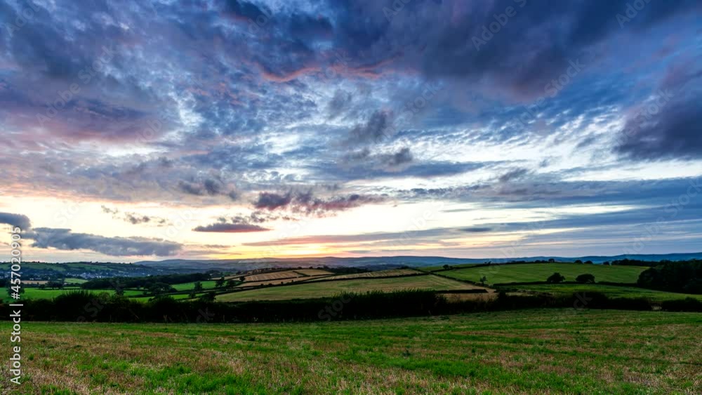 Sunset over the fields in Time Lapse Movie, Berry Pomeroy Village in Devon, England, Europe Sunset over the fields in Time Lapse Movie, Berry Pomeroy Village in Devon, England, Europe