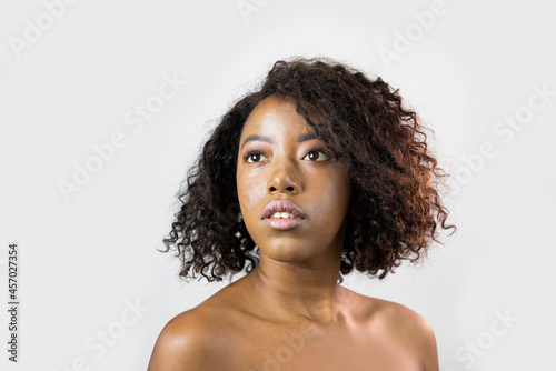 Beauty portrait of African American woman with clean healthy skin with afro hair . Beautiful black woman. Cosmetics, makeup and fashion