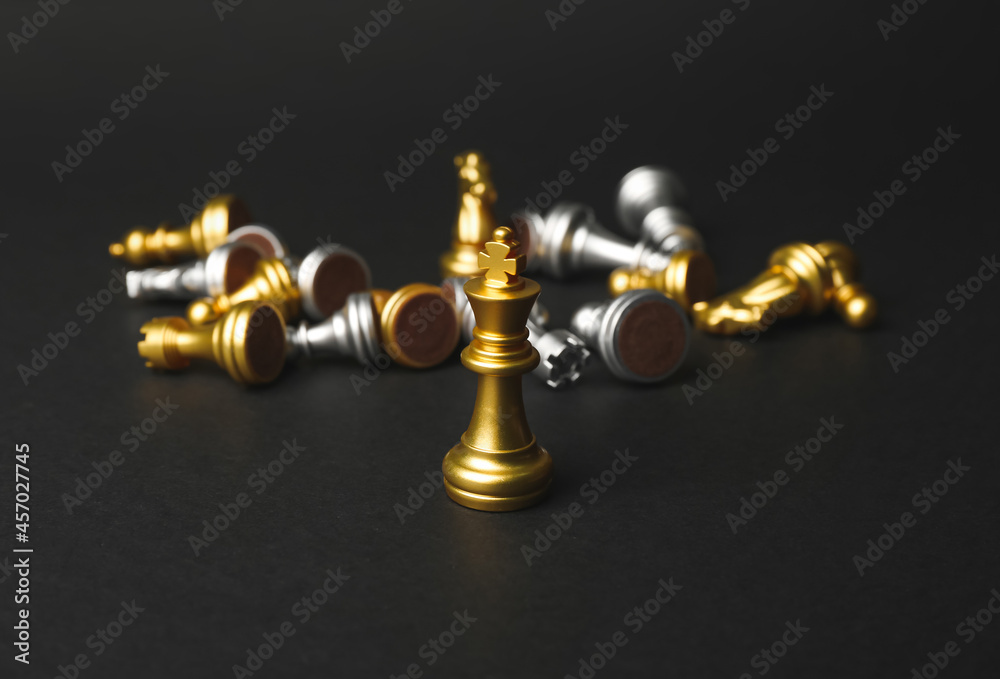 Golden king with chess pieces on dark background Golden king with chess pieces on dark background