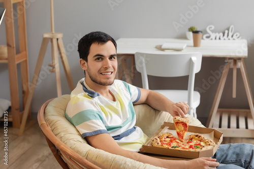 Handsome young man eating t...