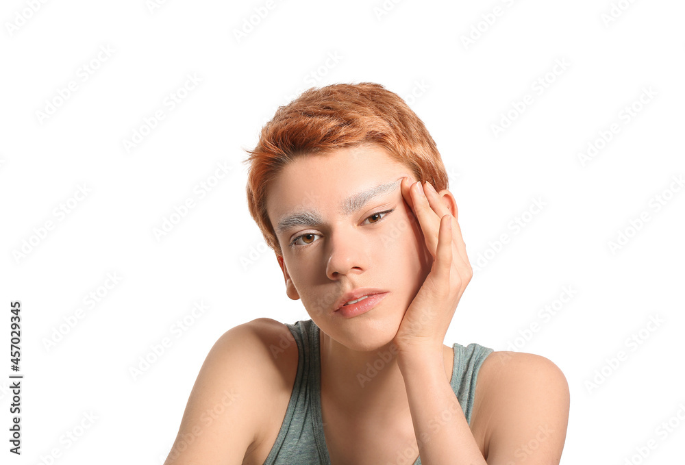 Teenage boy with dyed eyebrows on white background