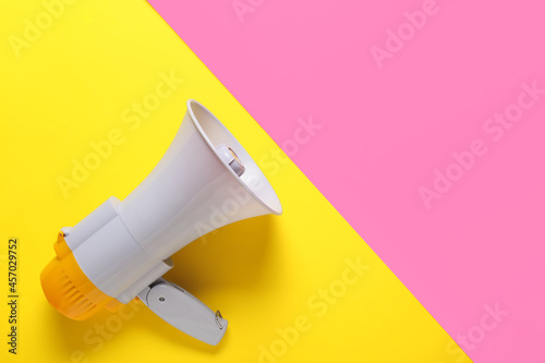 Modern megaphone on color background