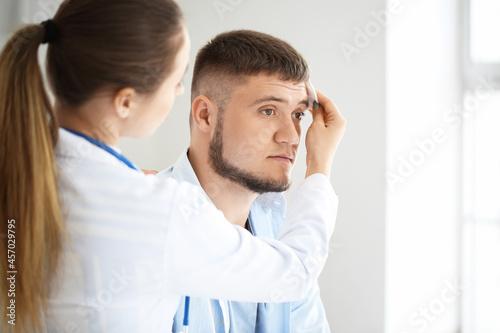 Doctor applying cotton pad ...