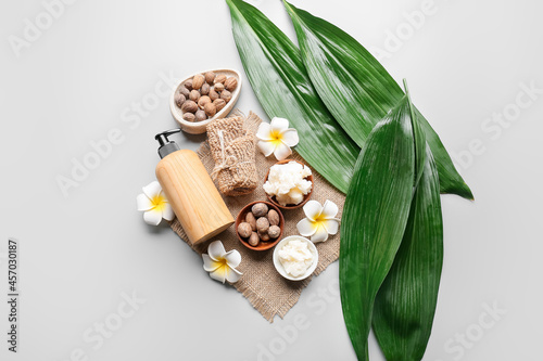 Composition with shea butter, nuts and bath supplies on light background