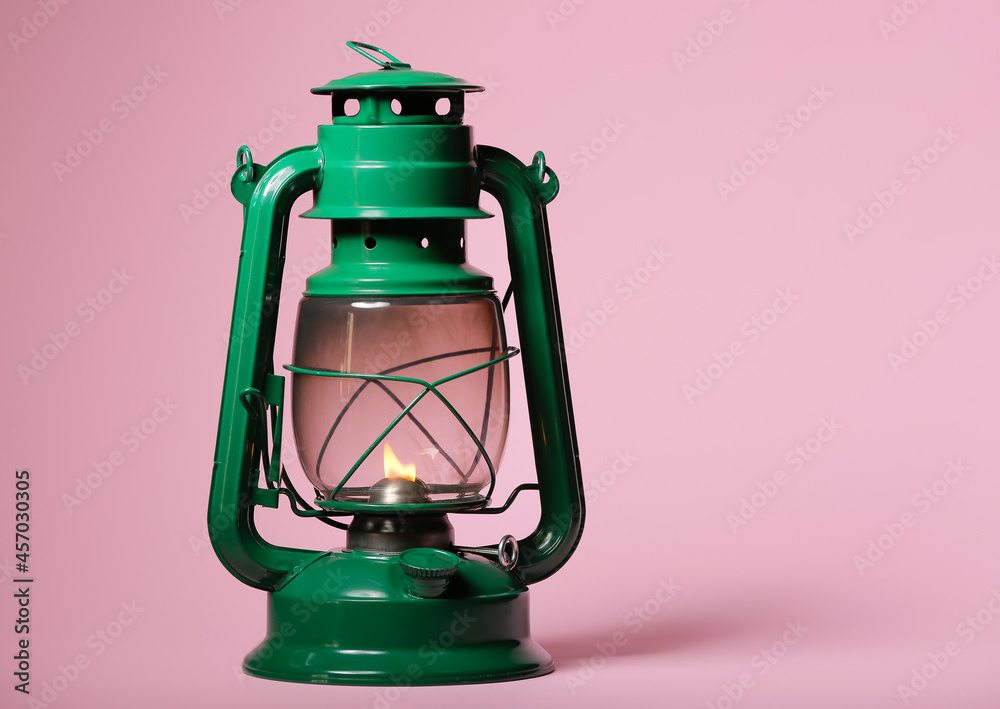 Stylish retro lamp on color background