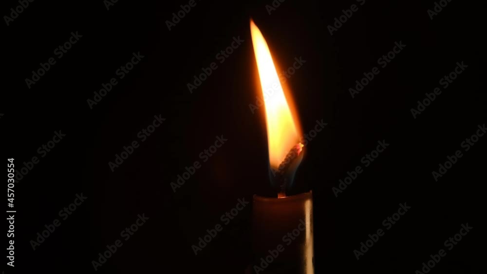 Candle flame in the dark. Candle light on black background. Lonely candle. Candle flame in the dark. Candle light on black background. Lonely candle.