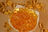 Fish Oil Gelantine Capsules in a ceramic bowl on a beige background .omega fatty acids Gelantine Capsule.Omega three acids. 
