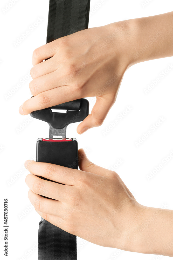 Woman fastening seat belt on white background Woman fastening seat belt on white background