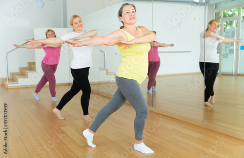 Active mature women enjoying training in dance studio, dance class for adults