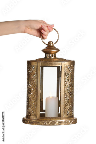 Hand with Islamic lamp on white background photo