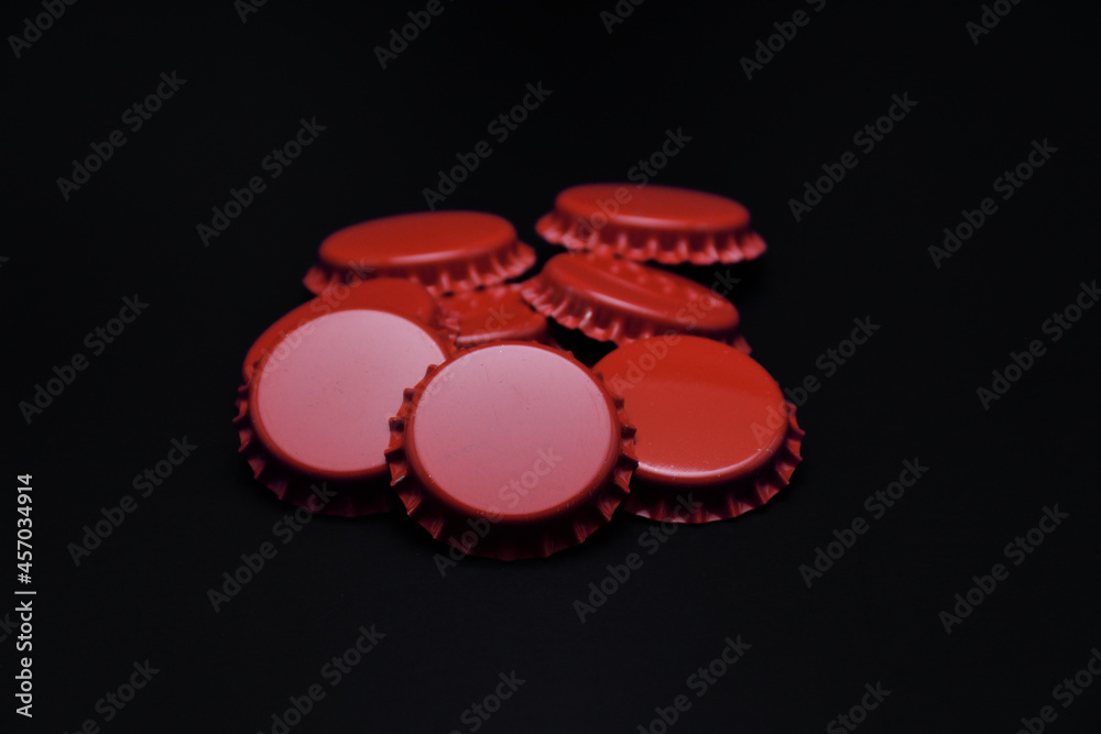 Red beer caps isolated on black background Red beer caps isolated on black background