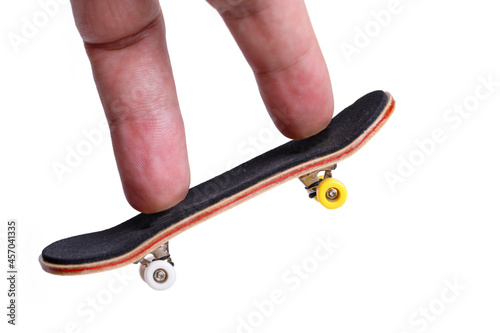 Man playing fingerboard on white background. photo