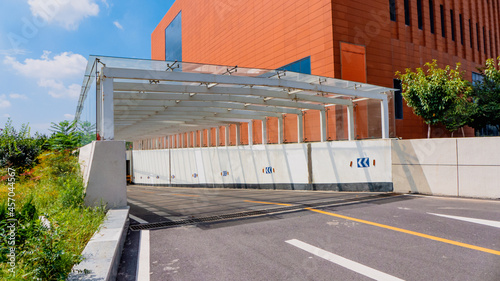 Entrance to the underground parking lot next to the brick red building