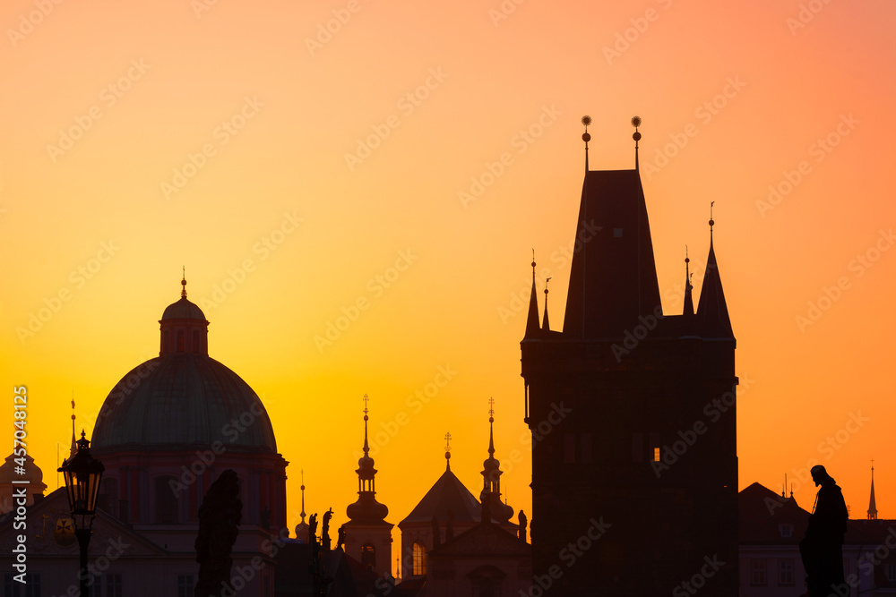 Sunrise over the capital of the Czech Republic - Prague city with silhouettes of buildings
