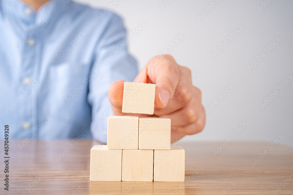 Hand arranging wood block stacking. Hand arranging wood block stacking.
