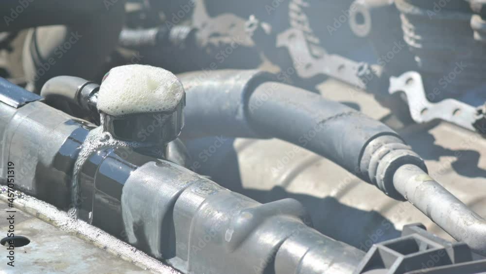 foam and bubbles come out of the filler neck of the car radiator. Antifreeze is poured out of the cooling system, radiator flushing, cooling malfunction in the car foam and bubbles come out of the filler neck of the car radiator. Antifreeze is poured out of the cooling system, radiator flushing, cooling malfunction in the car