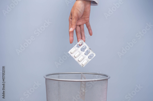 Wallpaper Mural Expired medicine. Woman's hand throws expired medicine in the trash. improper disposal of the drug Medicines should not be placed in trash or water sources. Torontodigital.ca