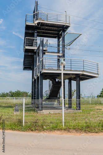 Multilevel observation tower under blue cloudy sky