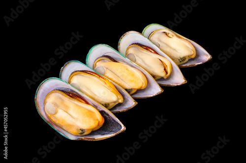 5 fresh peeled New Zealand mussels arranged isolated on a black background. popular seafood. Large New Zealand mussels prepared for cooking. photo