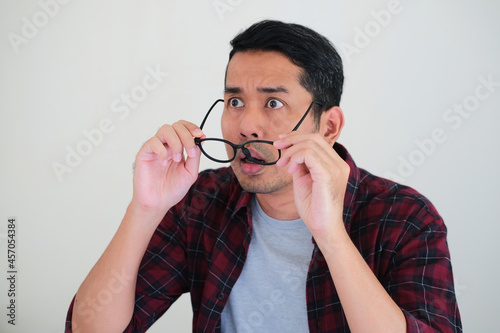 Asian man showing shocked face expression when looking ahead photo