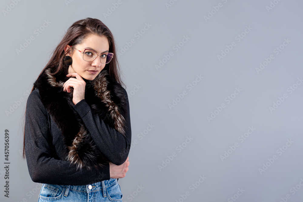 portrait of sensual woman in glasses  with long hair against gray background