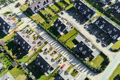 Modern residential district in Europe town, aerial view. Residential neigborhood, bird eye view. City streets with luxury house buildings and parked car