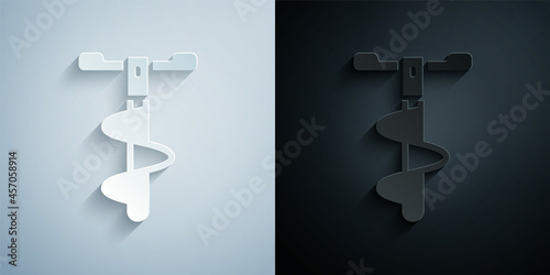 Paper cut Hand ice drill for winter fishing icon isolated on grey and black background. Paper art style. Vector