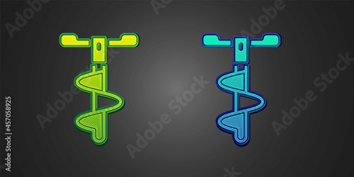Green and blue Hand ice drill for winter fishing icon isolated on black background. Vector © Iryna