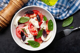 Caprese salad with fresh tomatoes, basil and mozzarella cheese