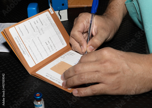 A veterinarian signing vaaccination records