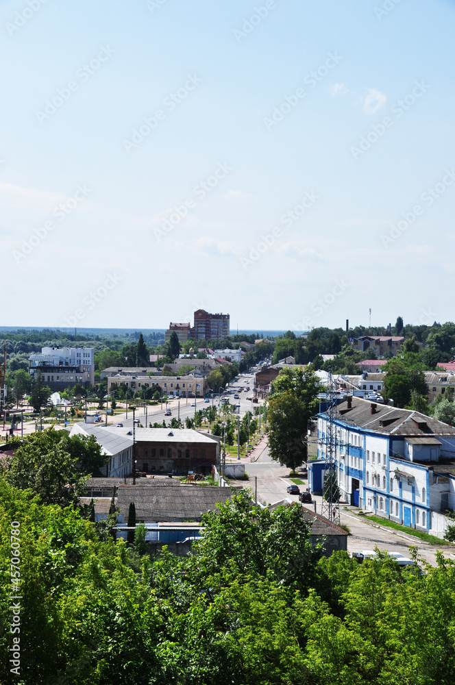 Panoramic view of the city. View from the top to residential buildings and a large street with cars.