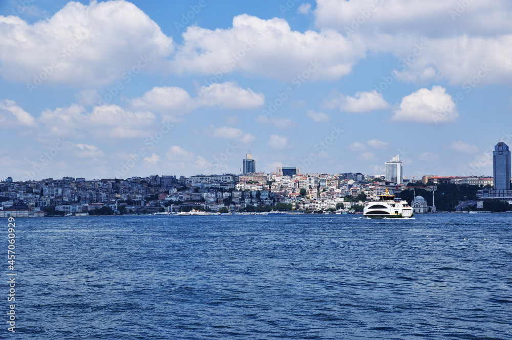 Panoramic view of Istanbul. Strait of Bosphorus, ship and coastline with houses. 09 July 2021, Istanbul, Turkey.