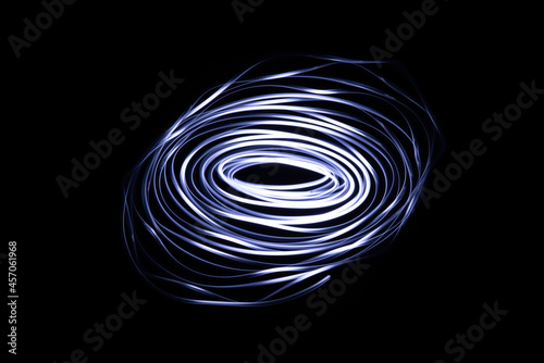 Long exposure of a tiny light swirling over the camera