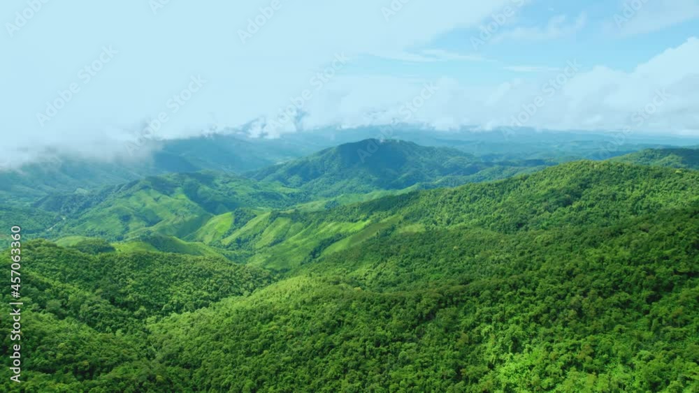 Aerial view drone shot of flowing fog waves on mountain tropical rainforest In the evening,Bird eye view image over the clouds Amazing nature background with clouds and mountain peaks. Aerial view drone shot of flowing fog waves on mountain tropical rainforest In the evening,Bird eye view image over the clouds Amazing nature background with clouds and mountain peaks.