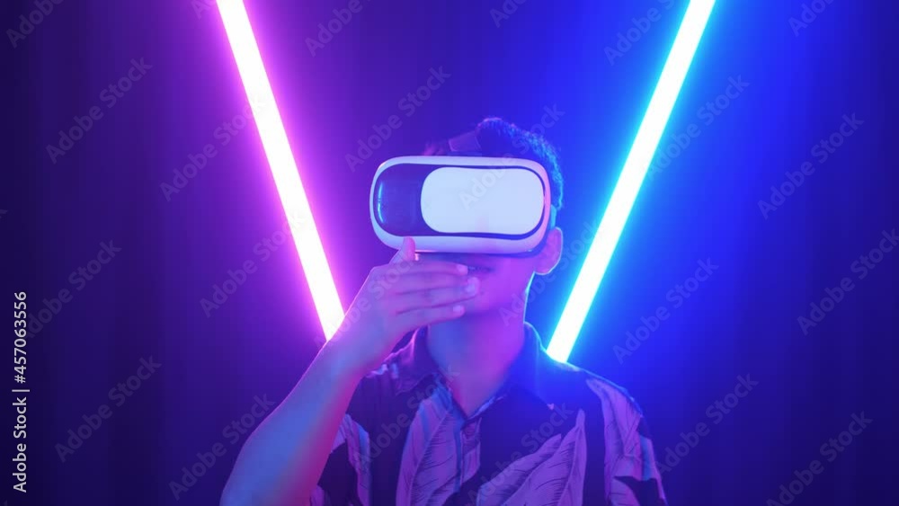 Vr, Futuristic, Entertainment Concept. Excited Asian Boy Using Virtual Reality Headset And Use Hand Slide With Neon Light At The Back Ground
Vr, Futuristic, Entertainment Concept. Excited Asian Boy Using Virtual Reality Headset And Use Hand Slide With Neon Light At The Back Ground