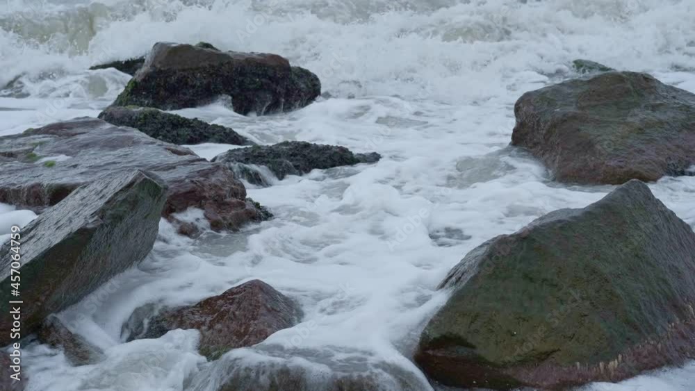 Strong sea waves crushing about coastal stone boulders Strong sea waves crushing about coastal stone boulders