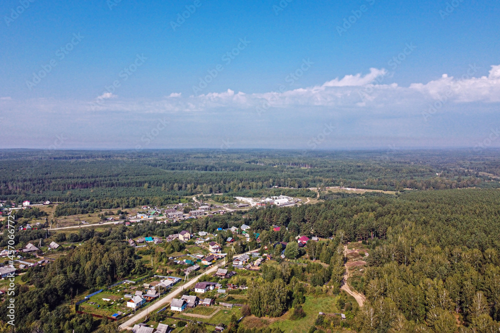 Top view of a small settlement in the forest on a summer day