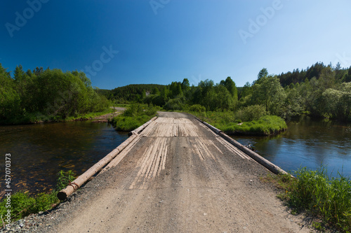 old wooden bridge across the ural river © Дмитрий Солодянкин