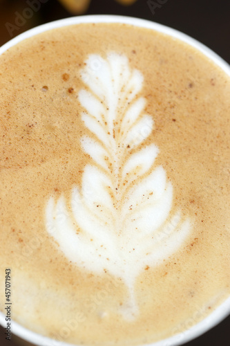 Cappuccino in a paper cup, foam close up