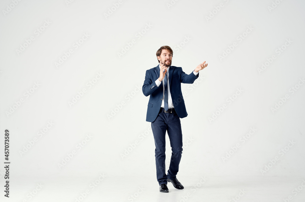 The man in a suit posing executive light background The man in a suit posing executive light background