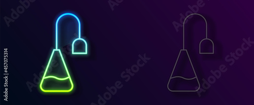Glowing neon line Tea bag icon isolated on black background. Vector