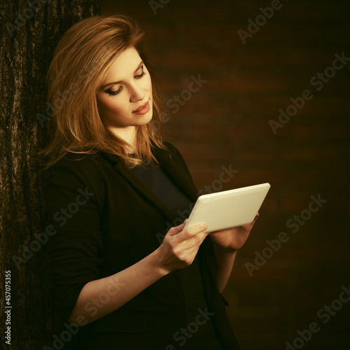 Young fashion blonde business woman using tablet computer