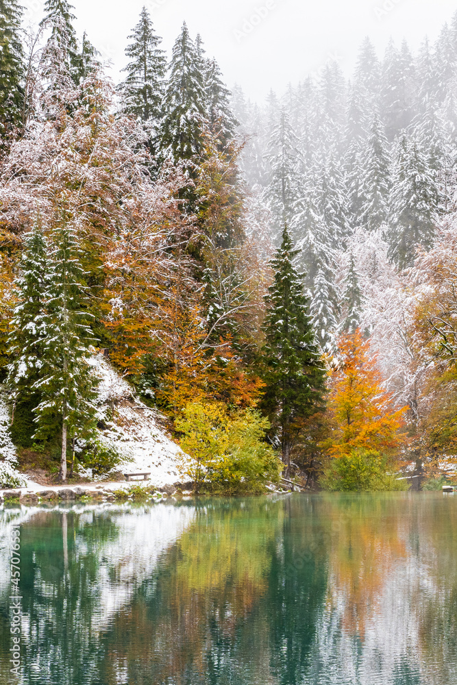 Between autumn and winter. Warm and cold reflections of snow on Lake Fusine. Between autumn and winter. Warm and cold reflections of snow on Lake Fusine.
