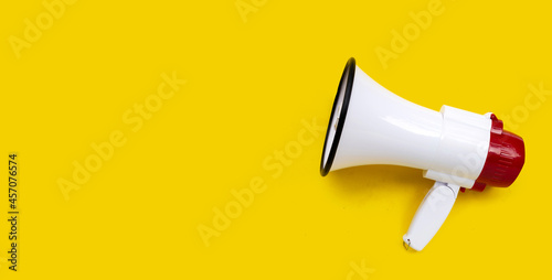 Red and white megaphone on yellow background.
